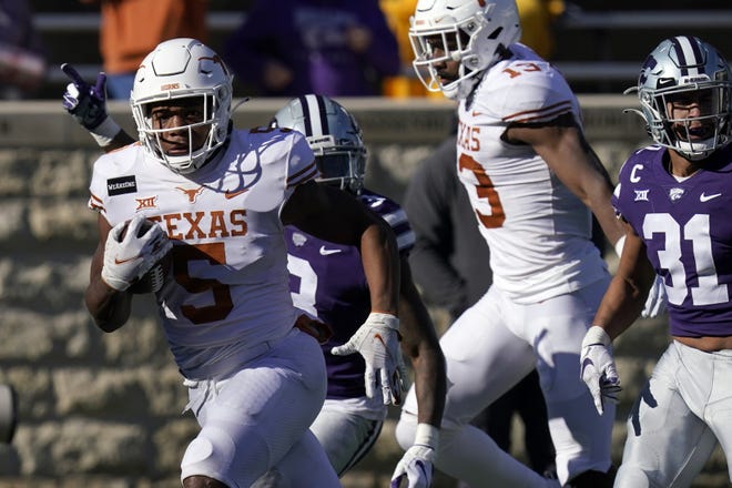 Texas running back Bijan Robinson breaks free for a touchdown during the first half of against Kansas State in Manhattan, Kan., on Saturday. Robinson scored three touchdowns in the game.