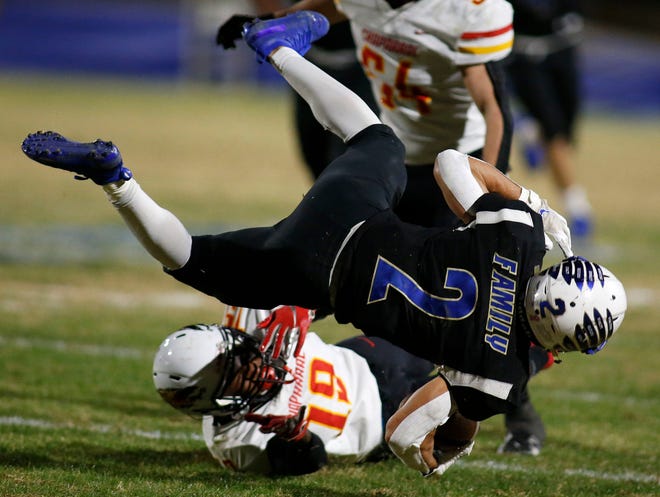 Sandra Day O'Connor's Donavin Fontaine (2) gets tripped up by Chaparral's Davondre Bucannon (19) during their 6A semi-final game in Phoenix, Friday, Dec, 4, 2020.