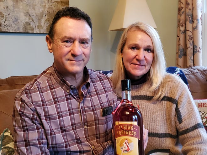 Portsmouth residents Daniel and Eileen Doyon show off the cocktail created by Dan, now appearing in New Hampshire state liquor stores. Dan, who is battling cancer, decided now was the perfect time to market Flying Fortress, Red Head, something family and friends have been urging him to do for years. 