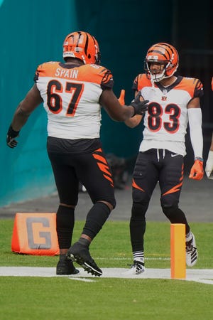 Cincinnati Bengals offensive guard Quinton Spain (67) congratulates wide receiver Tyler Boyd (83) after Boyd scored a touchdown during the first half of an NFL football game against the Miami Dolphins, Sunday, Dec. 6, 2020, in Miami Gardens, Fla. (AP Photo/Wilfredo Lee)