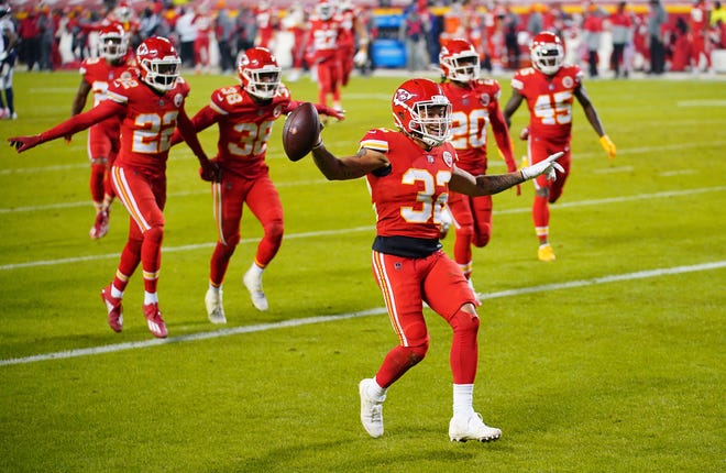 Kansas City Chiefs strong safety Tyrann Mathieu (32) celebrates with teammates after an interception during the second half against the Denver Broncos on Sunday night at Arrowhead Stadium in Kansas City.