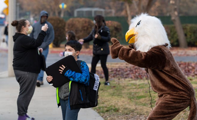 Pinkham mascot Eddie the Eagle greets Pinkham Elementary School students returning to classrooms Monday, December 7, 2020. Visalia Unified School District leaders have said they are adhering to federal health protocols.