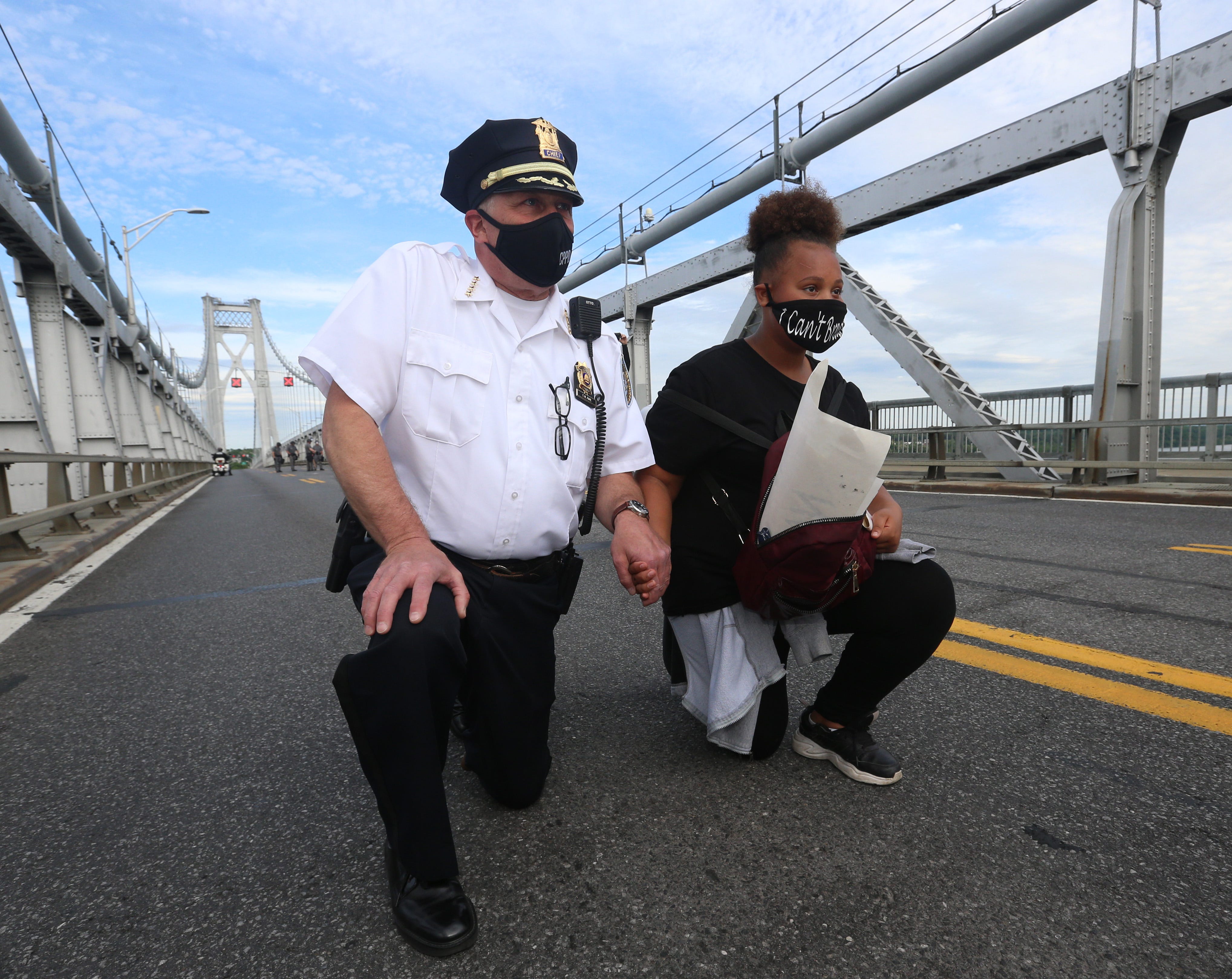 At the height of the coronavirus pandemic across the nation, New Yorkers took pause with the rest of the country to stand for racial justice. Here City of Poughkeepsie Police Chief Thomas Pape kneels with protestor Olivia Mima-Canada on the Mid-Hudson Bridge during a June protest.