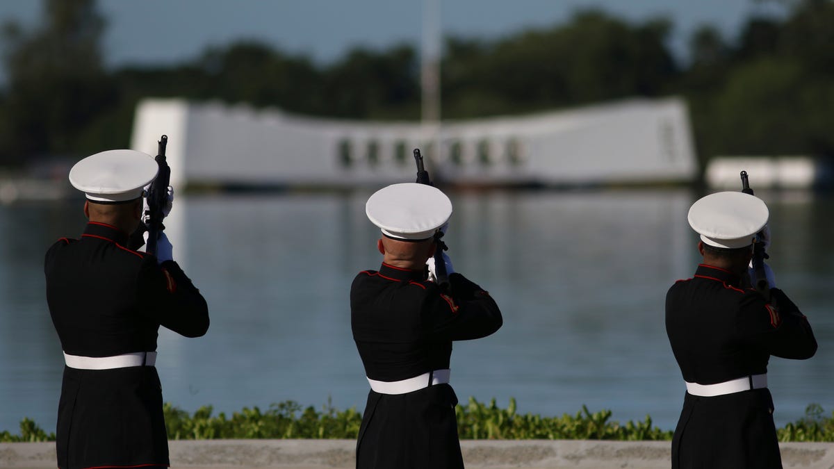 U.S. Marine perform in front of the USS Arizona Memorial during a ceremony to mark the 78th anniversary of the Japanese attack on Pearl Harbor, Saturday, Dec. 7, 2019 at Pearl Harbor, Hawaii.
