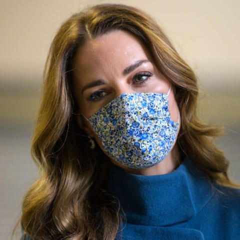 Duchess Kate of Cambridge dons a mask during a vis