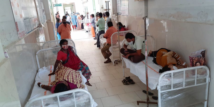 Patients and their bystanders are seen at the district government hospital in Eluru, Andhra Pradesh state, India, Sunday, Dec.6, 2020. Over 200 people have been hospitalized due to an unidentified illness in this ancient city famous for its hand woven products.