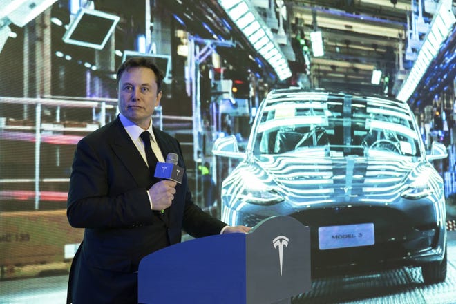 Tesla CEO Elon Musk speaks at a delivery ceremony for the first Tesla Model 3 cars made at Tesla's Shanghai factory in Shanghai, Tuesday, Jan. 7, 2020. Tesla's Shanghai factory delivered its first cars to customers Monday, and chief executive Elon Musk said the electric automaker plans to set up a design center in China to create a model for worldwide sales. (Chinatopix via AP)