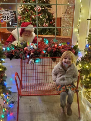 Quinn Davis smiles for a picture with Santa