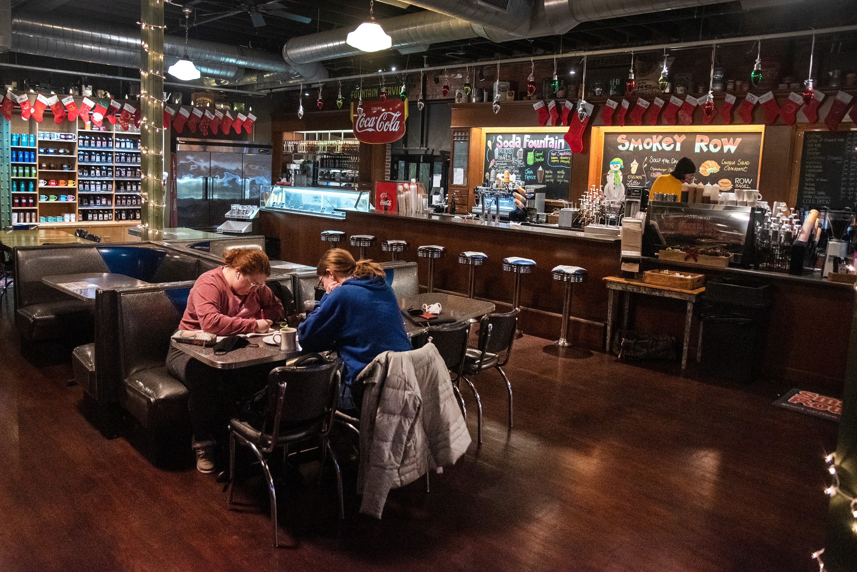 6:34 a.m.: Smokey Row's first customer of the day, Morgan Schrage (left) is joined by her roommate, Grace Kaetterhenry, to study for finals on Tuesday morning. "I like to have a space where I can get coffee and just spend some time; I used to always see around five to ten people that I know here. Now it's just a few," Kaetterhenry said.