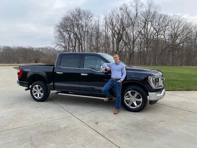Ben Brenneke, an accountant from West Lafayette, Indiana, is standing next to his 2021 Ford F-150 on December 8, 2020 after owning the vehicle just a few days.