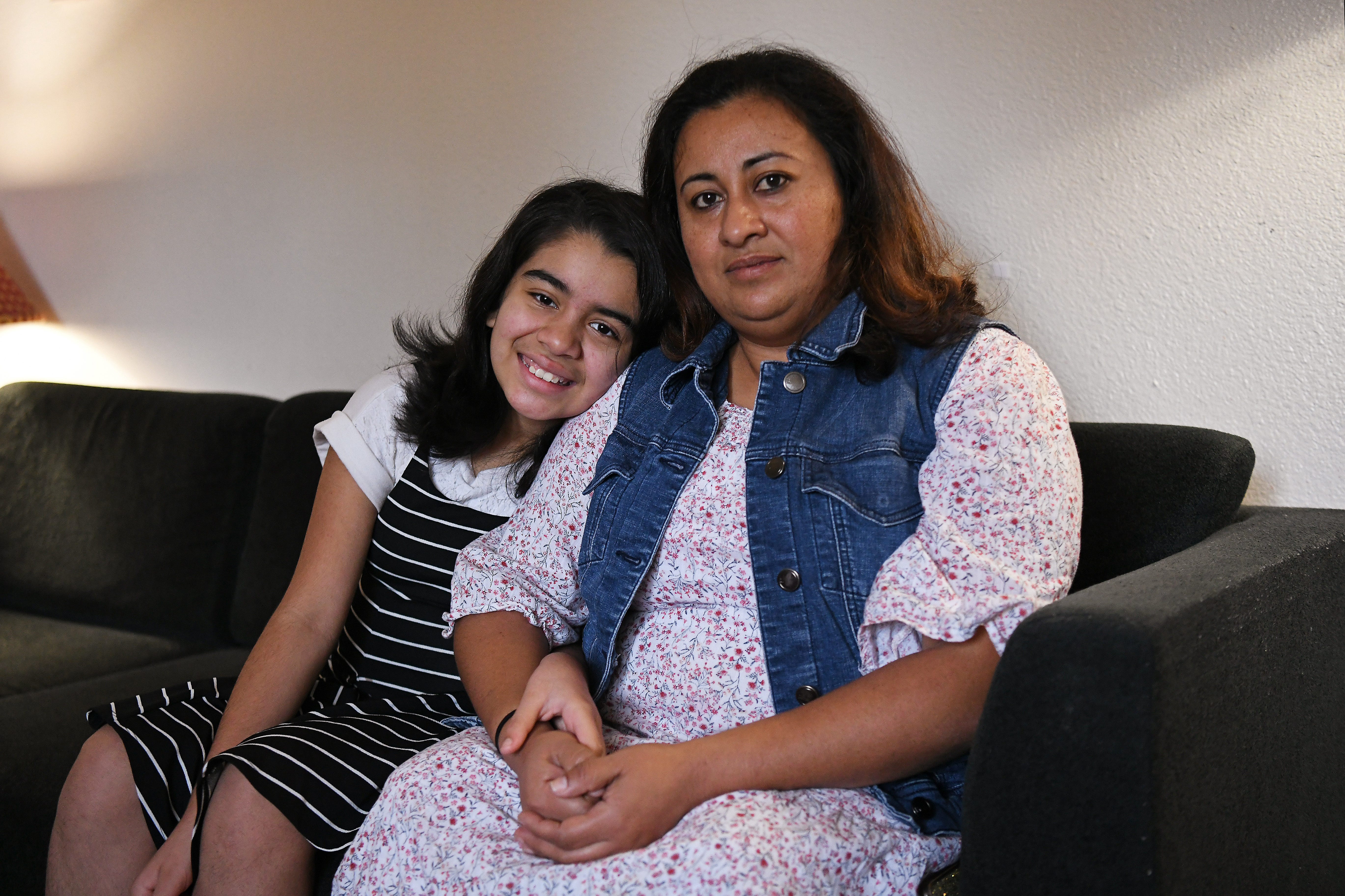 Aleida Susset Ramirez, 41, of Concord, sits with her daughter Emily, 11, at their home in Concord, Calif., on Monday, Nov. 9, 2020.