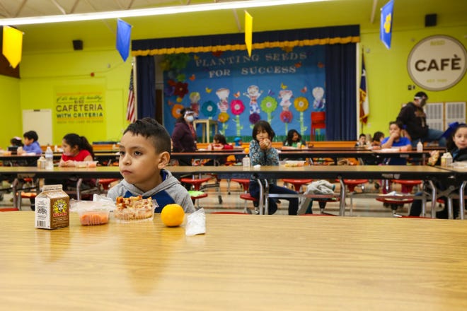 Sophomore Amado Soto eats socially distanced lunch with fellow students in the cafeteria of Perez Elementary School in Brownsville, Texas in 2020.