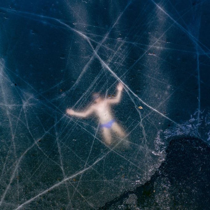 Aerial view shows Finland's free diver Kristian Maki-Jussila, 37, swimming under the ice of a frozen lake on March 28, 2020 near Vaasa, Finland. 
