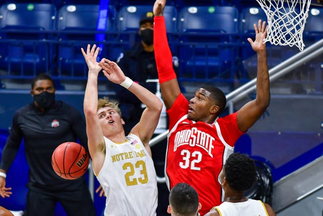 Ohio State forward E.J. Liddell (32) defends against Notre Dame guard Dane Goodwin of the Buckeyes' 90-85 win on Tuesday. Liddell finished with career highs of 19 points and 12 rebounds.
