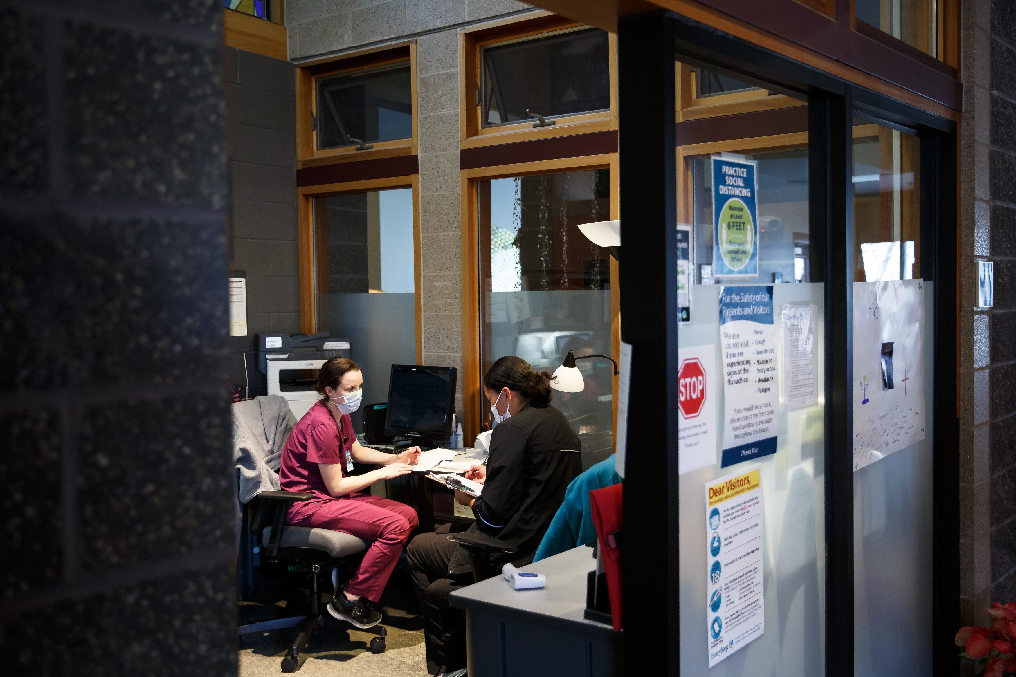 2:45 p.m. DES MOINES - Nurse Taylor Porter, 23 of Des Moines, left, and aide Josie Starks, 29 of Des Moines, right, go over their shift and update their notes at EveryStep Kavanagh House on Tuesday, Dec. 8, 2020, in Des Moines, IA. Porter, previously a nurse in a more traditional care setting, said the work is, "hard but rewarding."