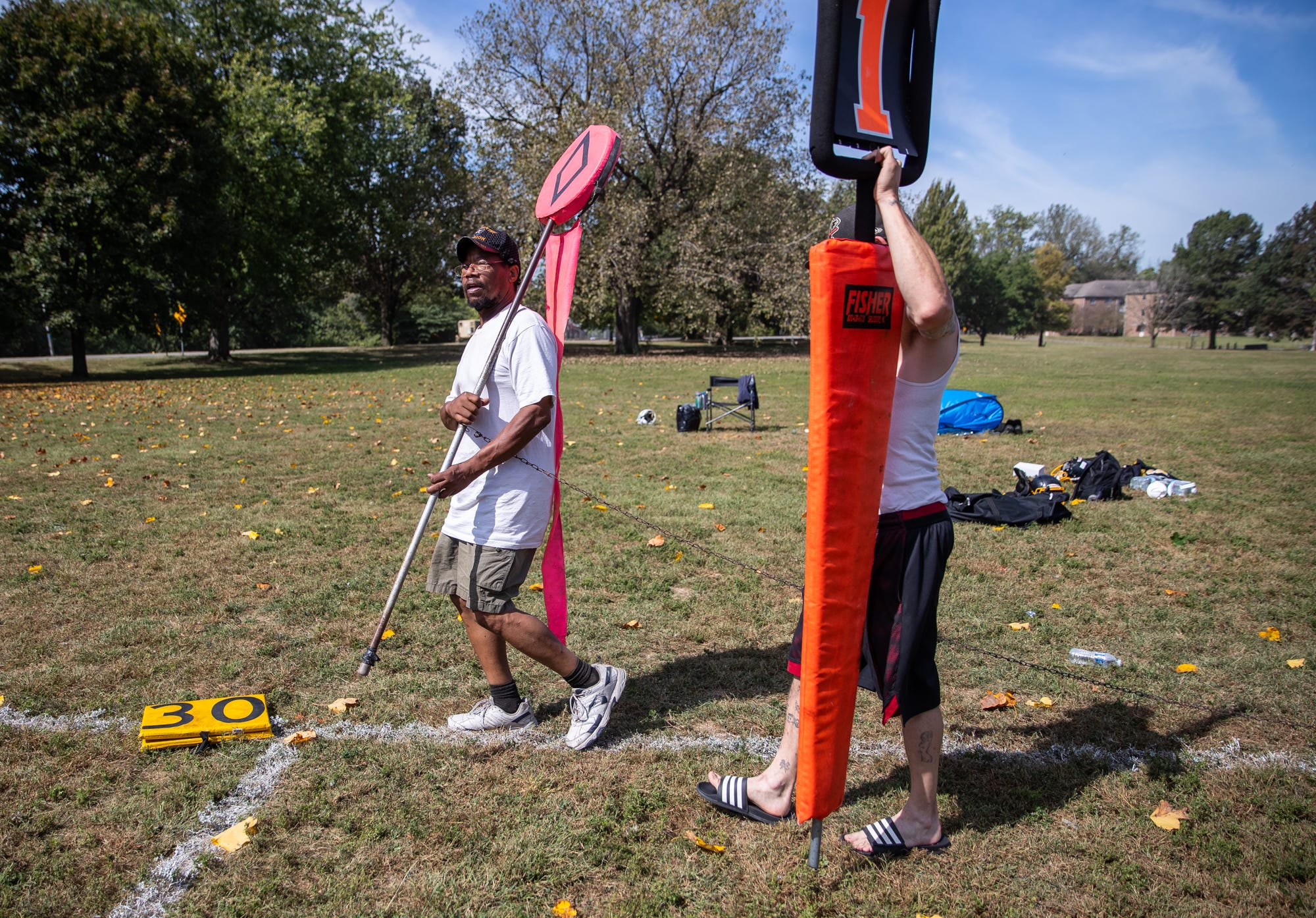 Robert O'Neil, father of Indy Steelers player Antonio, volunteers to be on the football chain crew during his son's game at Watkins Park on Sunday, Sept. 22, 2019. O'Neil would spend all day at the park, then head into work at his third-shift custodial job.