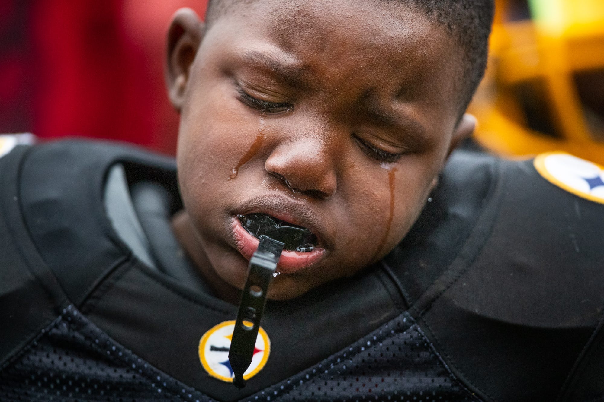 Tyson Delaney, 8, cries after the Indy Steelers' 8u team's overtime loss in the championship game against the City Colts on Saturday, Oct. 28, 2018. "You played your hearts out, keep those heads up," said coach Donnell Hamilton. Hamilton started the Indy Steelers in 2005 with the aim to keep kids on a positive path. Hamilton lost his full-ride college scholarship after an incident with friends where guns were in the car. Hamilton had to serve time in prison. He would not graduate. "I done been through what you been through. Your struggle is familiar for me," he said to the kids on his team. "So, going through my struggle, getting out of my struggle and becoming more positive in my life, that's what turned me into what I am today. A beautiful struggle."