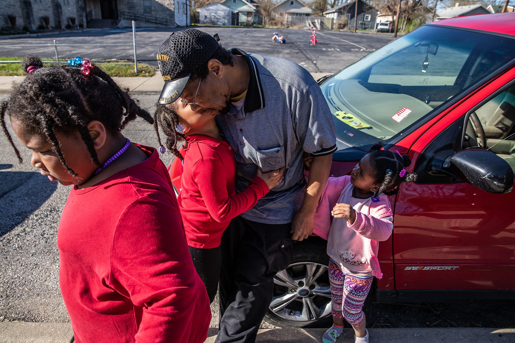 Robert O'Neil gets a hug from each of his girls, Mary, 8, Adriane, 6, and Angel, 3, on Monday, April 15, 2019. O'Neil is a single father of four, three girls and one boy, Antonio, 11. "I'm an old guy, I'm not a spring chicken no more, you know what I mean?" said Robert. "Having them kind of makes me feel young, they keep me going." The mother of the four children suffers from chemical and substance abuse, which is why, according to O'Neil, he is raising the children alone. 