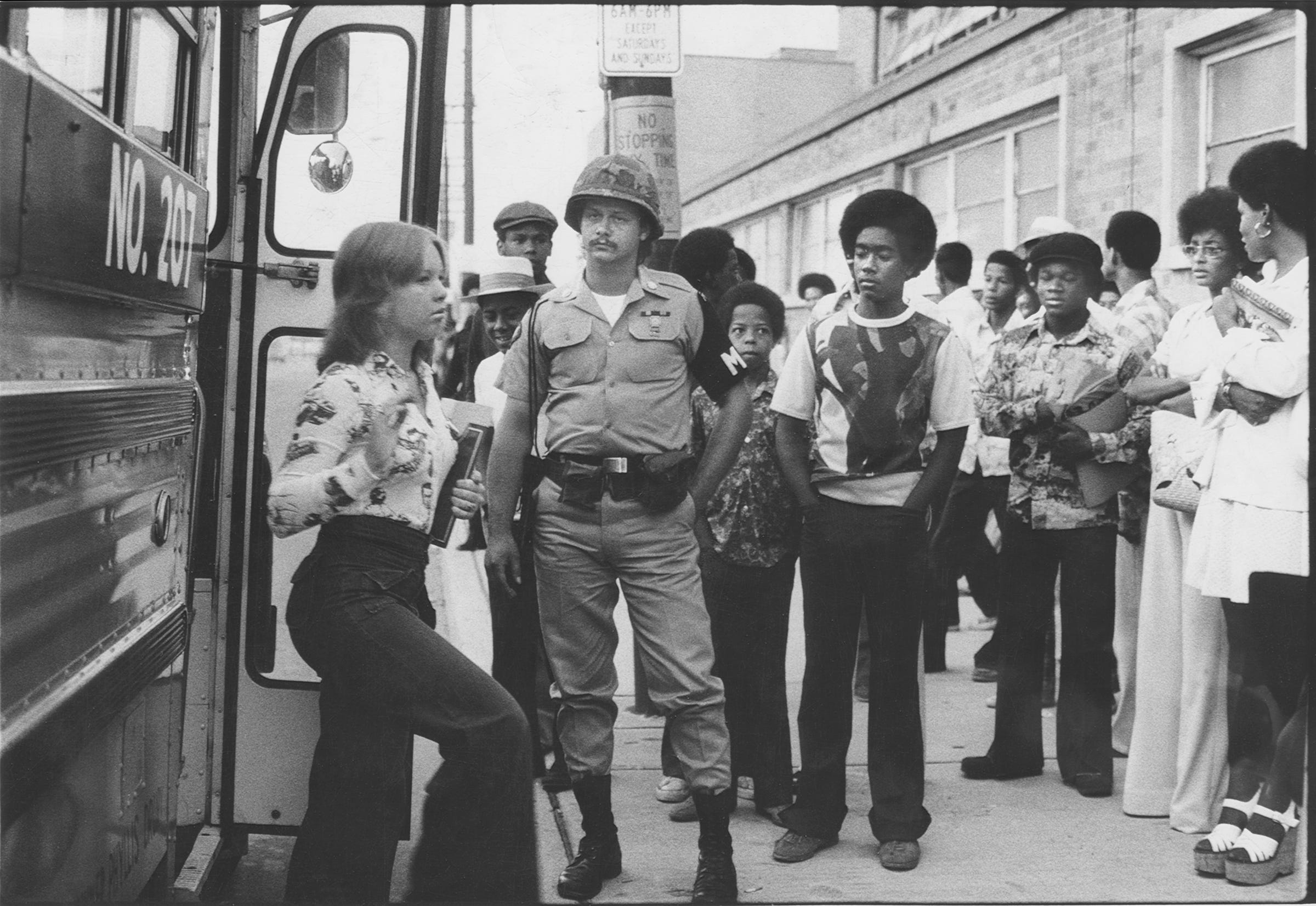 A National Guardsman watched as students arrived at Central High School during the first week of court-ordered busing in Louisville. By Bud Kamenish, The Courier-Journal. Sep. 8, 1975