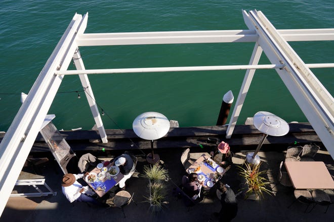 People dine outdoors at a waterfront restaurant in Sausalito, Calif., on Dec. 4, 2020.