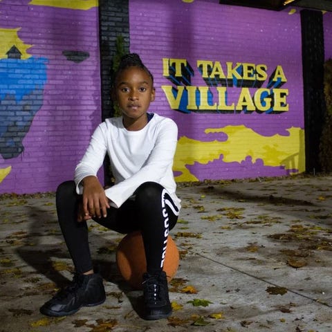 London Riley poses for a portrait in front of an I