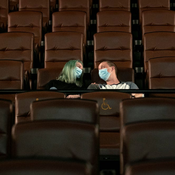 Kayleigh Tansey and Justin Smith, of Kyle, settle into their seats for a movie date at EVO Entertainment on Monday., May 4, 2020.