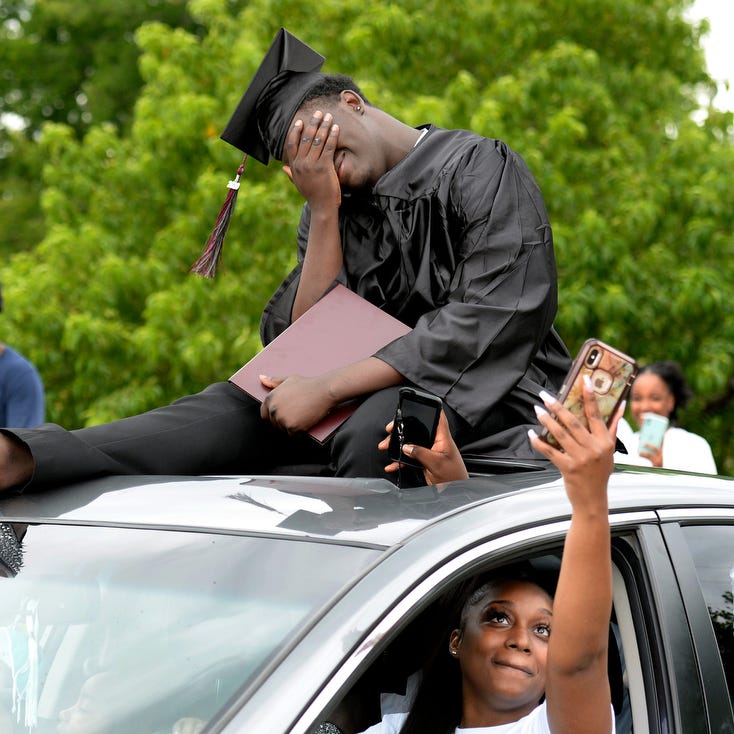 Maplewood High School senior Dedrick Woodard is emotional after receiving his diploma on Sunday, May 17, 2020, in Nashville, Tenn. The school hosted a drive-thru graduation procession at the high school to celebrate the class of 2020 during the coronavirus pandemic.