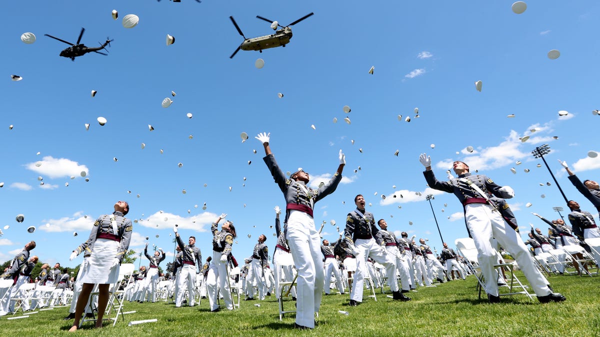 The 2nd lieutenants throw their covers in the air at the end commencement ceremony on the Plain at West Point in West Point, New York on June 13, 2020.