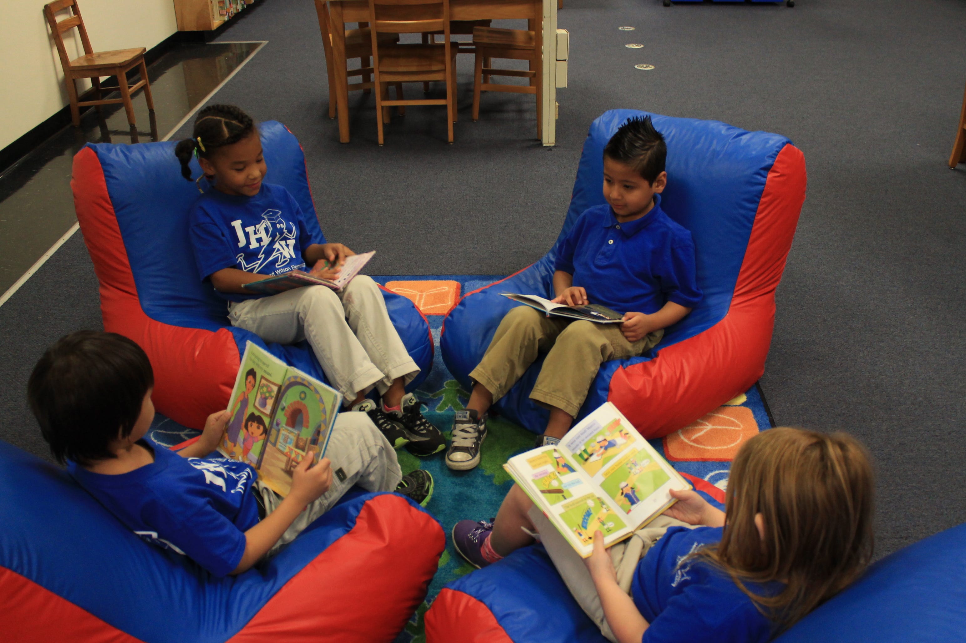 A group of students at Janie Howard Wilson Elementary School read books in a classroom.