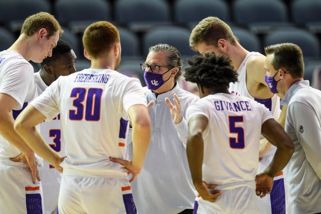 University of Evansville Head Coach Todd Lickliter, center, talks to the starting line up before the start of the home opener against the Eastern Illinois University Panthers at Ford Center in Evansville, Ind., Wednesday, Dec. 9, 2020.