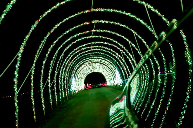 A car is driven through a tunnel of lights at Santa's Rock N Lights Show on Dec. 2, 2020, at the Brown County Fairgrounds in De Pere, Wis.