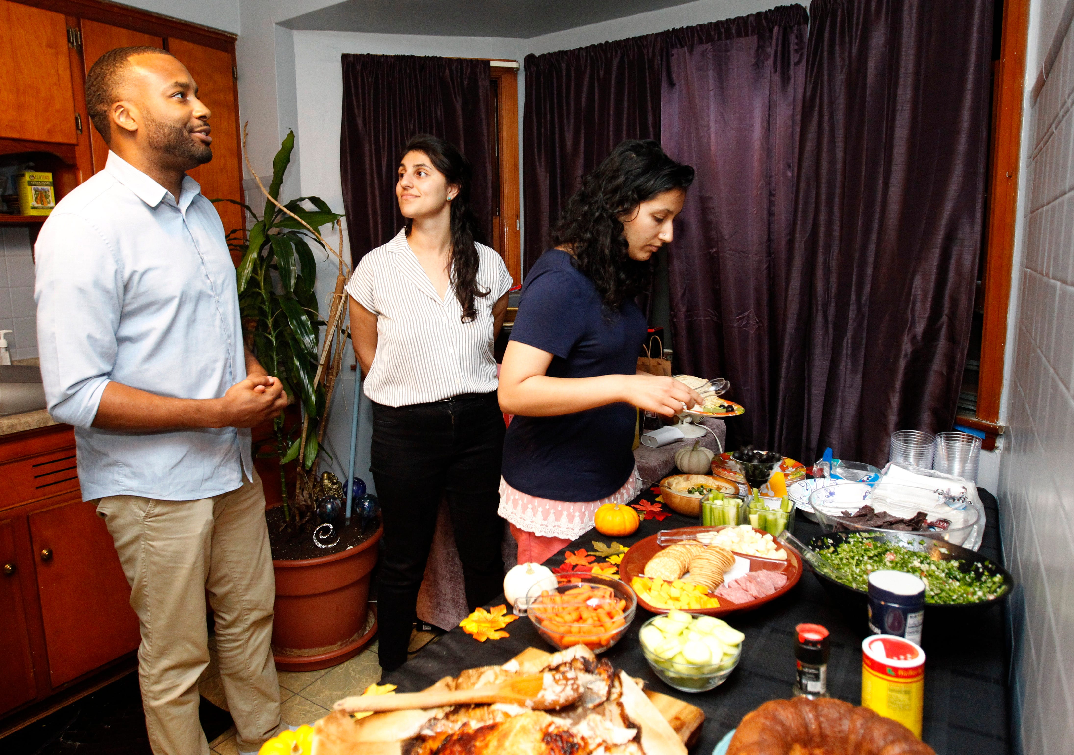 Earl Arms, from left, Minaliza Shahlapour and Priya Suri get dinner before joining others in discussions on race at an "On the Table MKE" event at the home of James E. Causey and his wife, Damia, in October 2019.