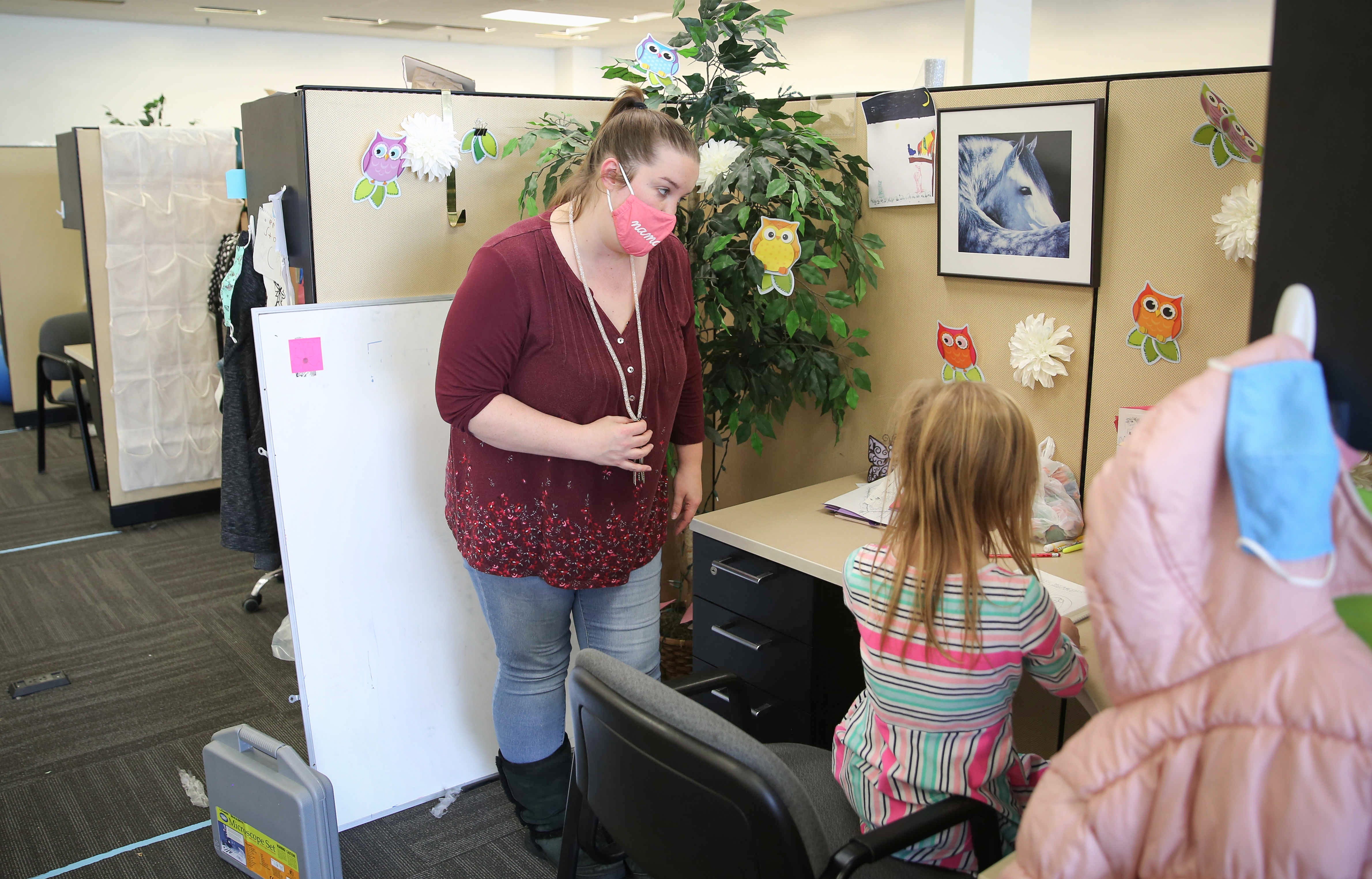 1327 DES MOINES -- Educator Aubrey Dooley helps Ella Gibson, 7, a second grader at Brubaker Elementary School, at InsideOut on Tuesday, Dec. 8, 2020, in Des Moines. COVID-19 has forced many school districts to go to an online learning, and Dooley said she works with four different school districts to help students learn. 