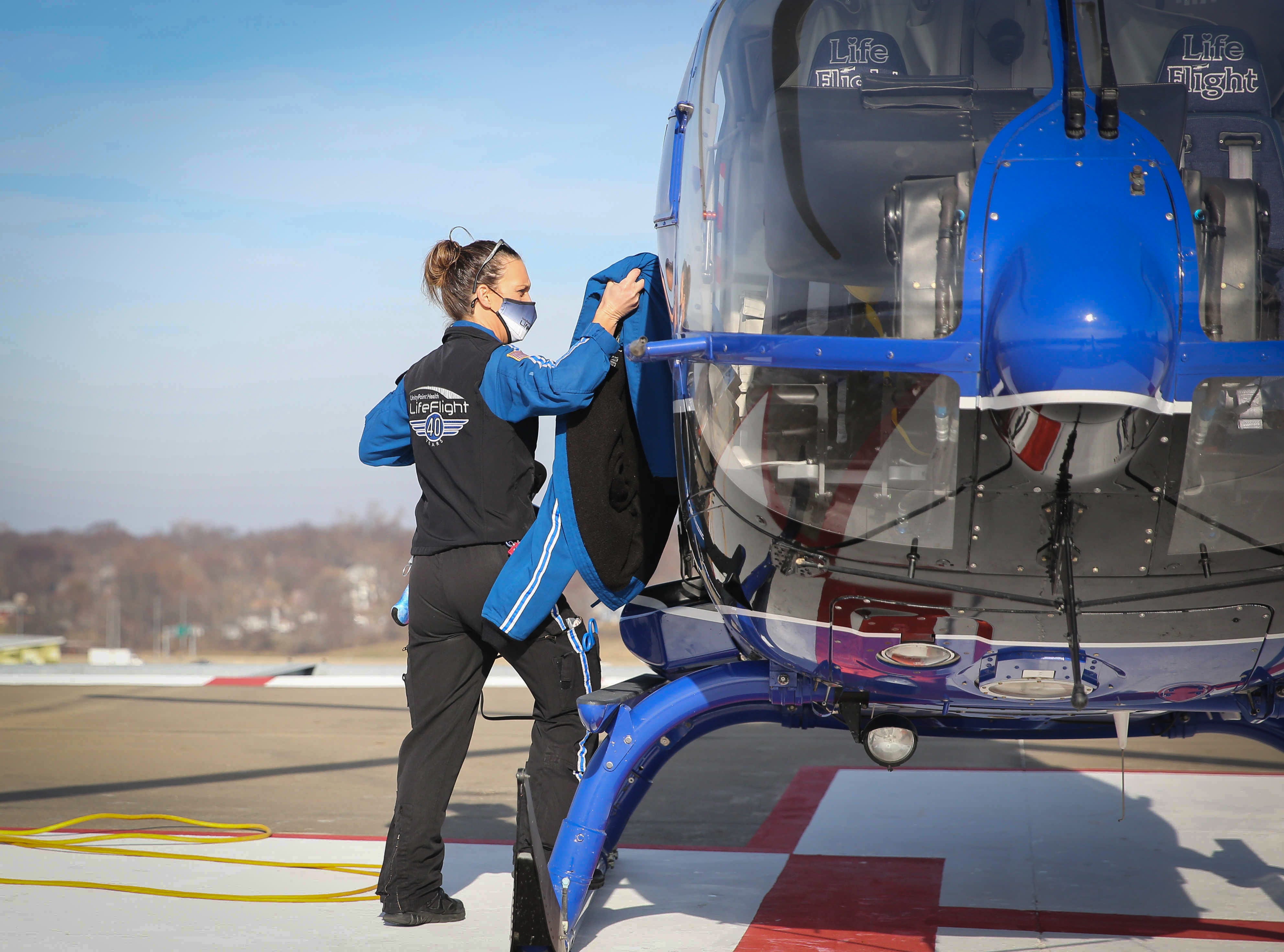 1128 DES MOINES -- UnityPoint LifeFlight nurse Jerrica Moon loads her equipment onto a helicopter after clearance was given to fly again, on Tuesday, Dec. 8, 2020, at Methodist Hospital in Des Moines. Earlier that morning, heavy fog had grounded all helicopters.
