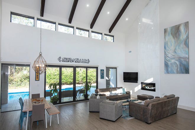 The living space is brimming with natural light and overlooks the pool.