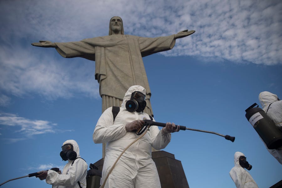 Soldiers disinfect the Christ the Redeemer site, currently closed, to prepare for what tourism officials hope will be a surge in visitors in the upcoming weekend as health restrictions are eased amid the new coronavirus pandemic in Rio de Janeiro, Brazil, Thursday, Aug. 13, 2020.