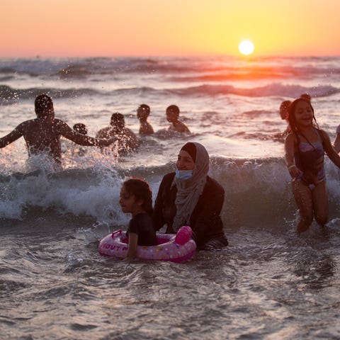 People enjoy the mediterranean sea during the Eid 