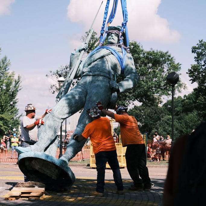 Workers prepare to load the monument to confederate soldiers and sailors onto a flatbed truck on July 8, 2020 in Richmond, Virginia. Mayor Levar Stoney ordered the immediate removal of all Confederate statues from city land.