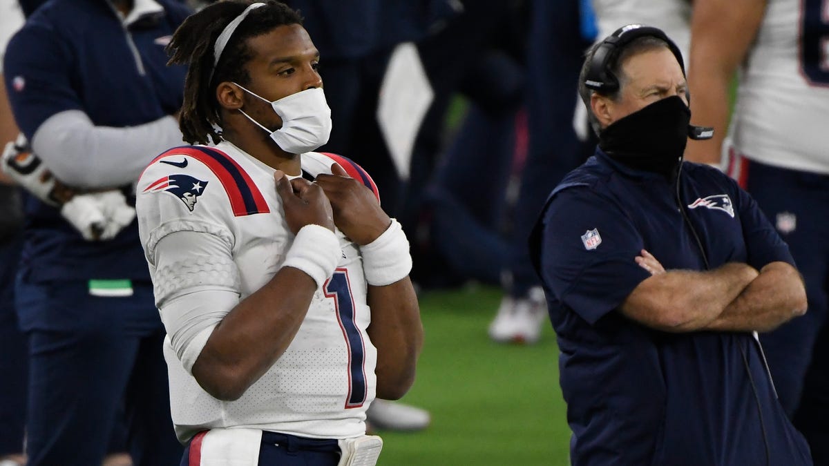Patriots quarterback Cam Newton looks on from the sidelines after being replaced in the fourth quarter against the Los Angeles Rams Thursday.