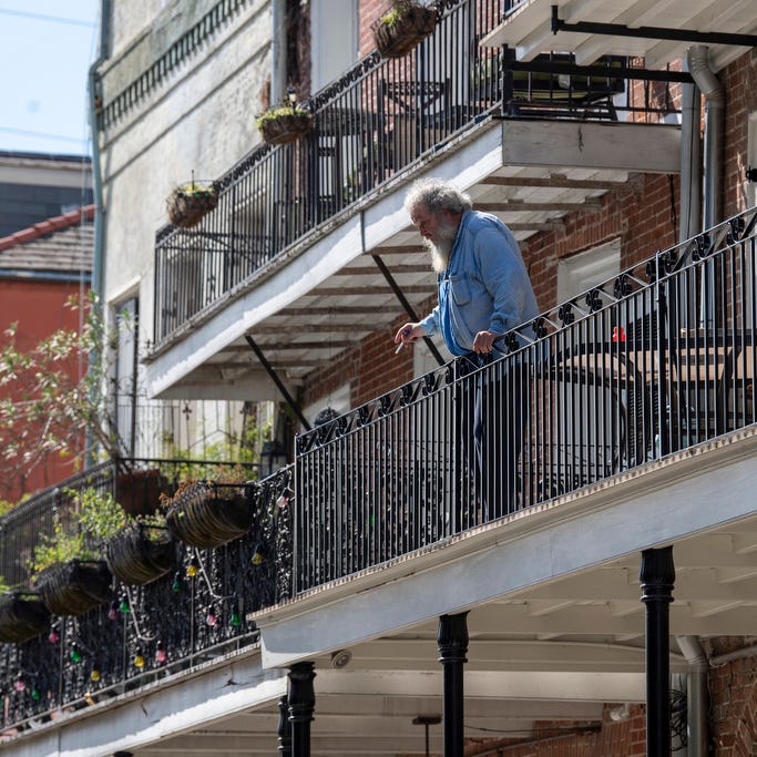 Cliff Ocheltree leans on the railing of his balcony in the French Quarter on the day Tropical Storm Marco was expected to hit the Gulf Coast on Aug. 24, 2020.