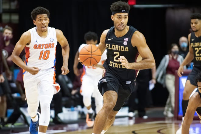 Florida guard Noah Locke, left, and his teammates return to playing basketball Wednesday at Vanderbilt