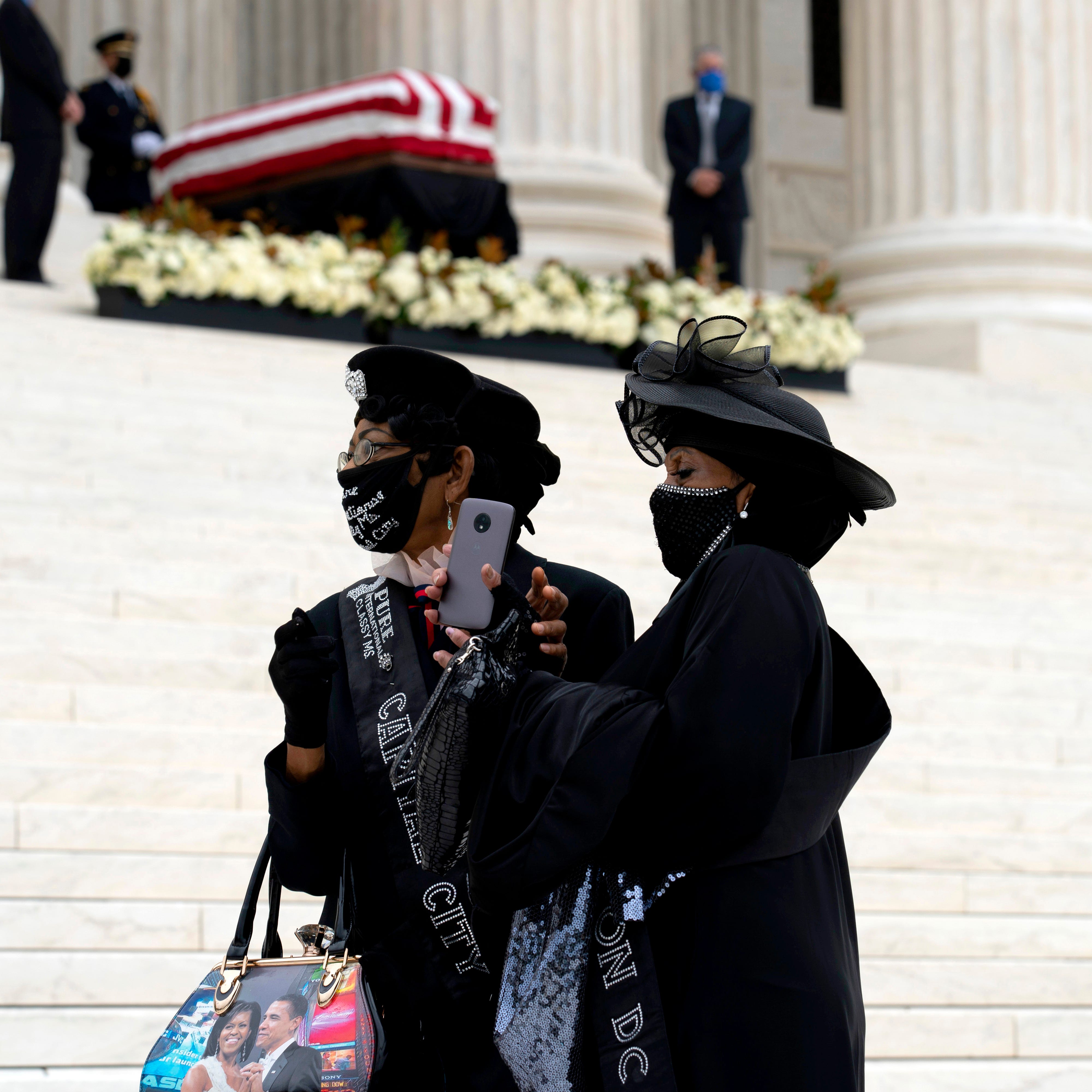 Mourners pay respects as Justice Ruth Bader Ginsburg lies in repose under the Portico at the top of the front steps of the U.S. Supreme Court building on Thursday, Sept. 24, 2020, in Washington.