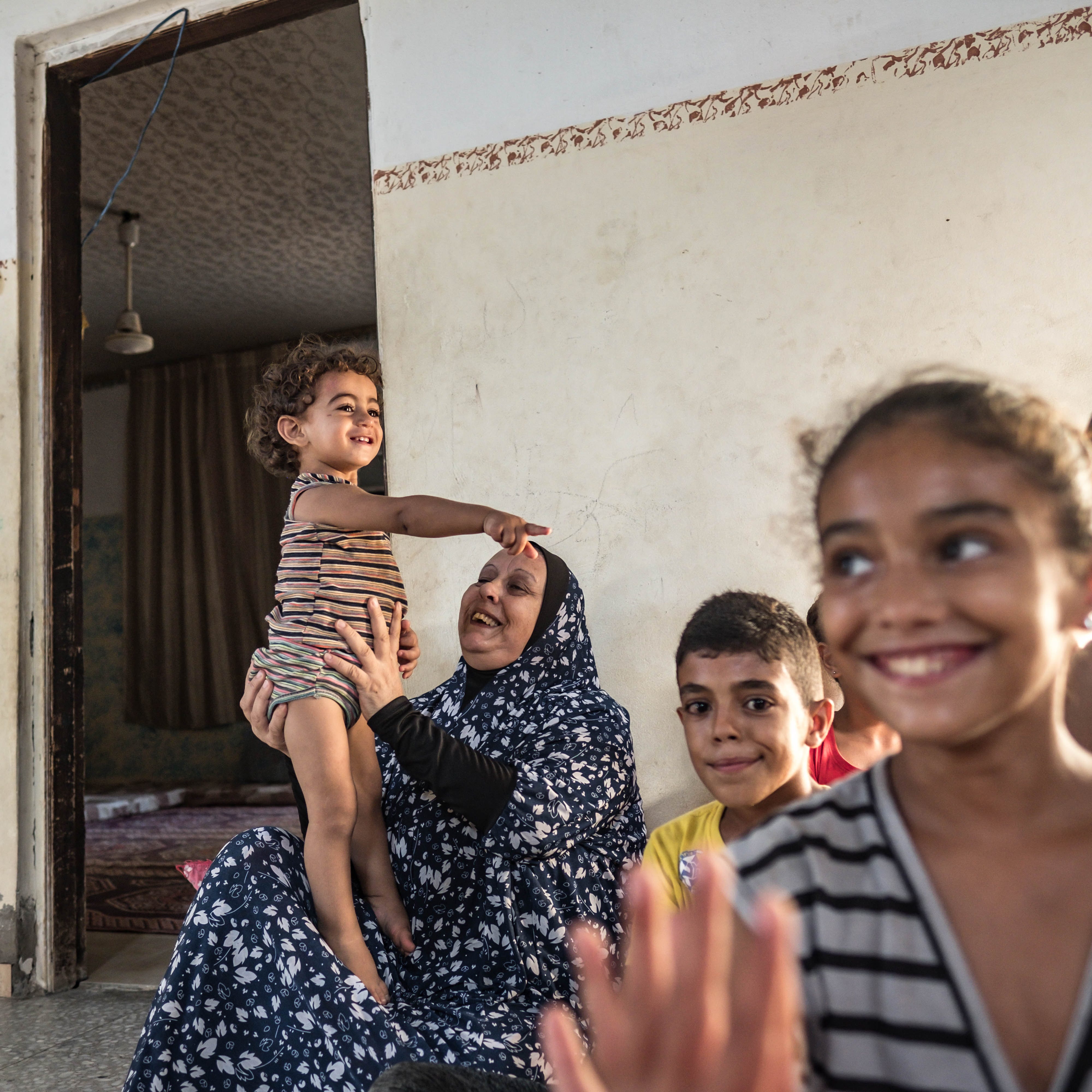 Suad Al-Dairi plays with her grandson in their house during a coronavirus lockdown in the Al-Karamah neighborhood on September 02, 2020 in Gaza City, Gaza. 