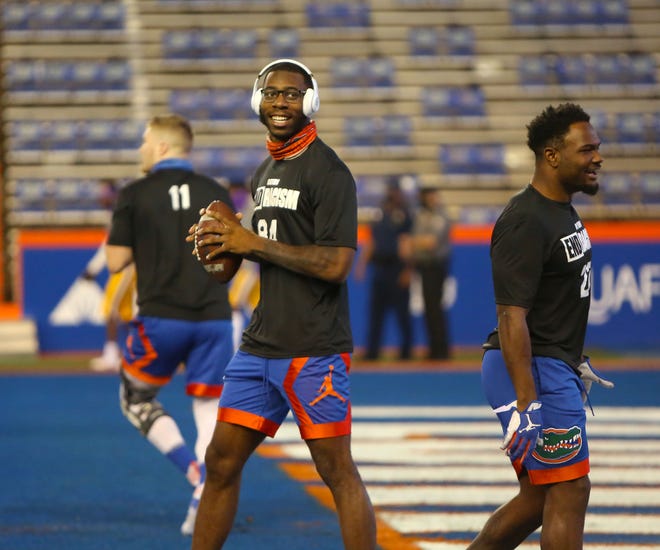Florida tight end Kyle Pitts (84) jokes with other players during warmups Saturday before the game against LSU at Ben Hill Griffin Stadium. Pitts was a late scratch from the game because of a prior injury.
