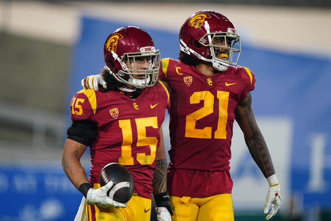 USC safety Talanoa Hufanga (15) celebrates with safety Isaiah Pola-Mao after an interception in the fourth quarter against UCLA.
