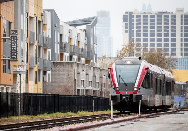 A MetroRail train runs alongside East Fifth Street on Feb. 19. The commuter line will become part of a larger Austin rail system after voters approved Project Connect in November.