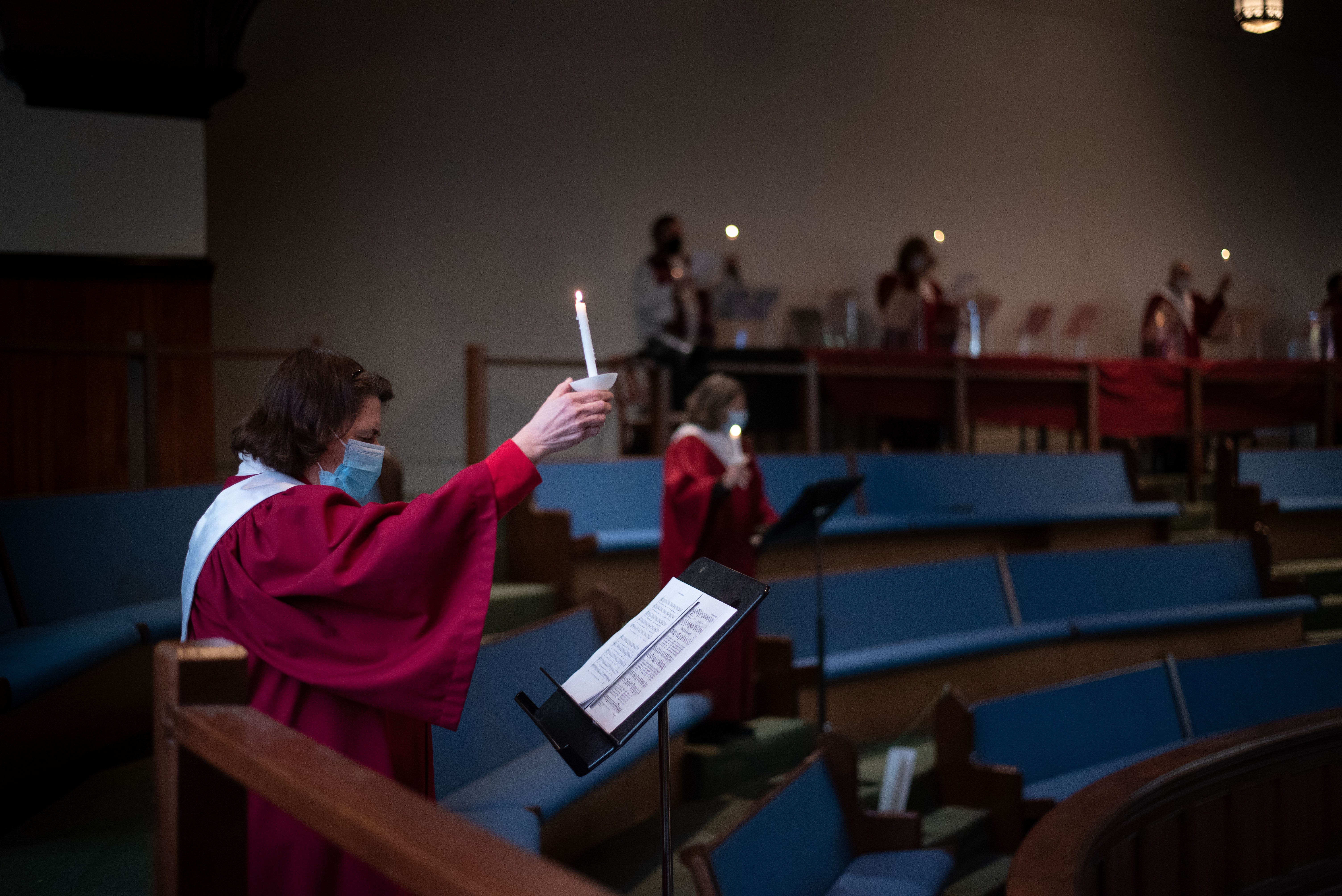 Masked and about a dozen feet from others in the church choir, Liz BarVinchak sings "Silent Night" at Tabernacle United Methodist Church in Binghamton on Saturday, Dec. 12, 2020.