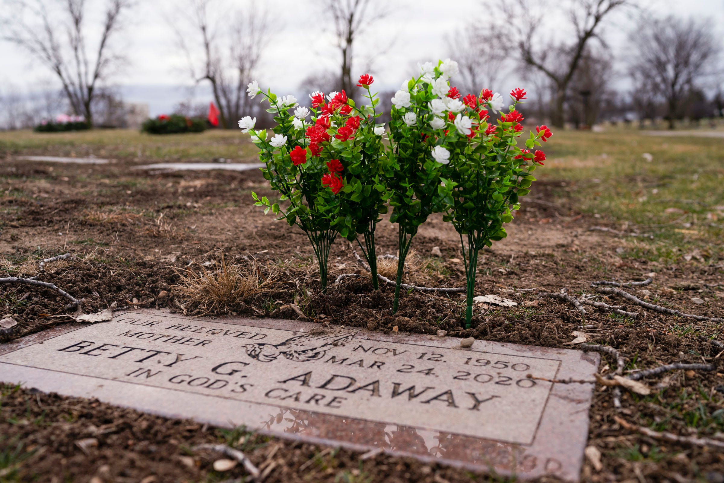 Fresh flowers are placed at Betty Gene Adaway's grave marker at the Detroit Memorial Park on Sunday, Dec. 6, 2020, in Redford Township.