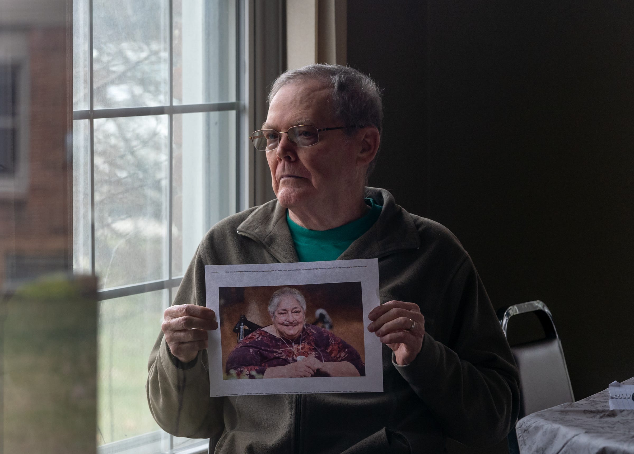 Dennis Reading holds a photo of his wife, Laura Reading, who he lost to COVID in March, on Friday, December 4, 2020. She lived in an assisted living facility in Troy.