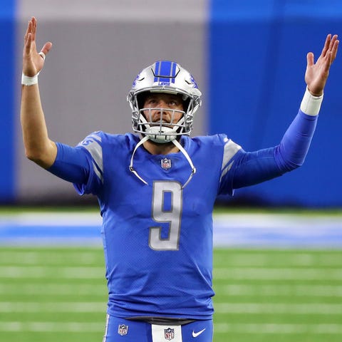 Matthew Stafford of the Detroit Lions signals for 